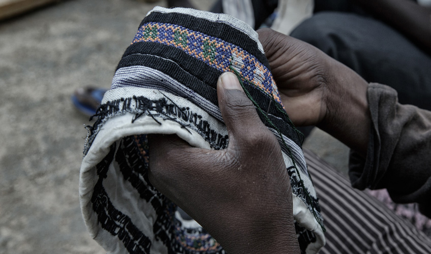 Close up of hands holding an embroidred cloth