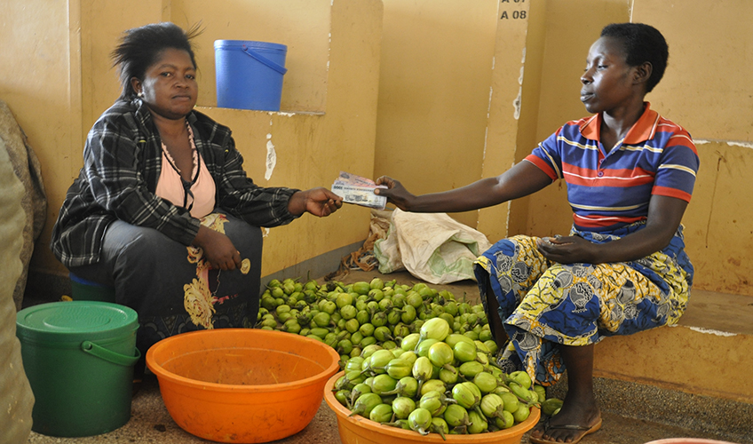 Claudine serving a customer at her stall 