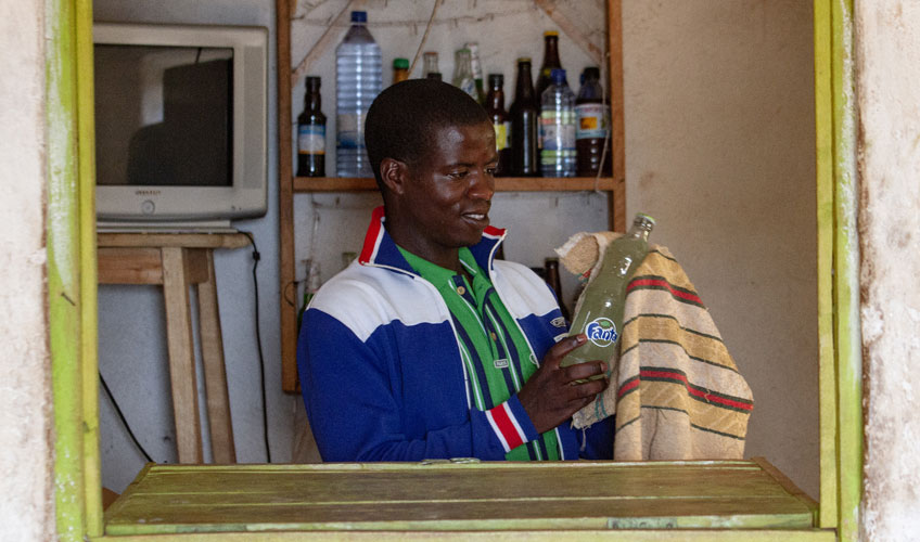 Evariste wiping a bottle