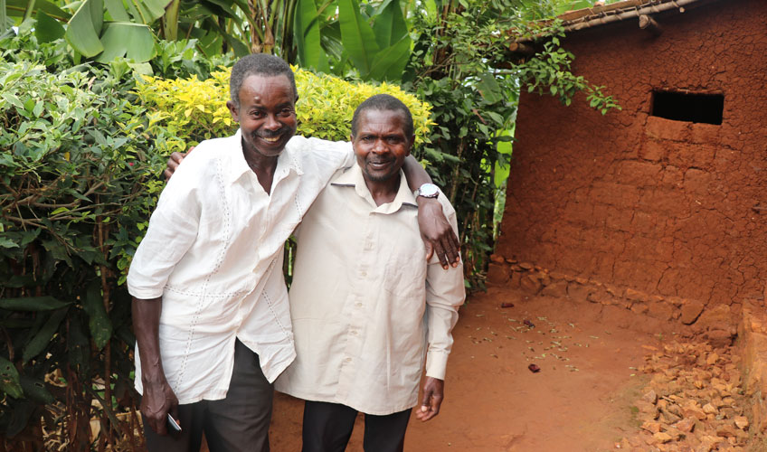 Two friends pose in their community.