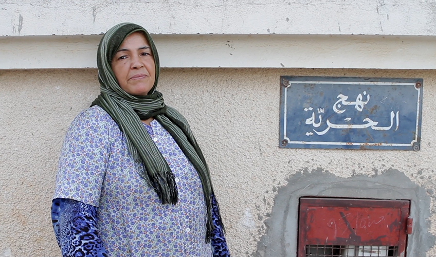  Portrait of Zohra El-Jlassi standing in the street.