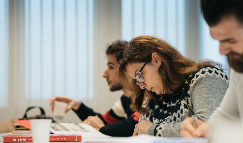 Rahaf studying at a desk with others