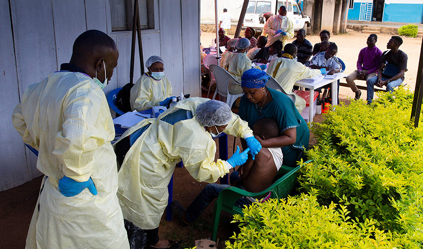 An African child receives a vaccination from a medical worker