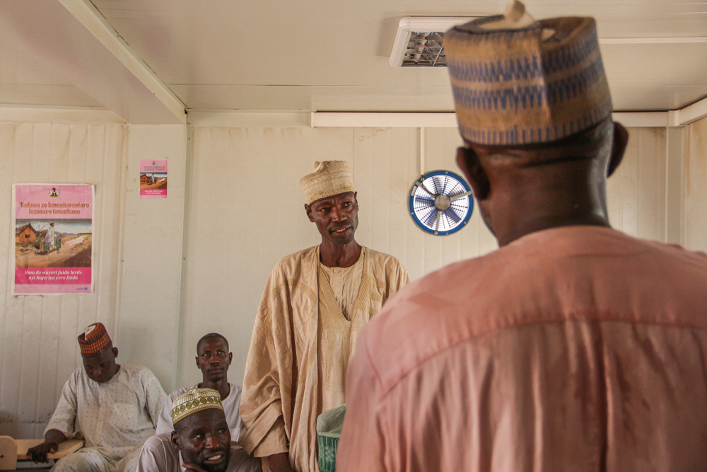 Abdullahi in a meeting with several other men