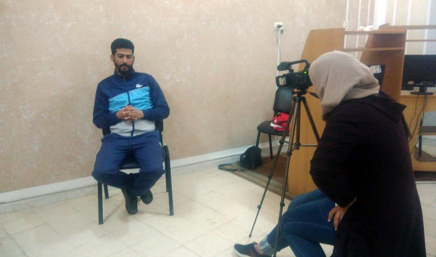 A Tunisian woman interviews a Tunisian man on camera