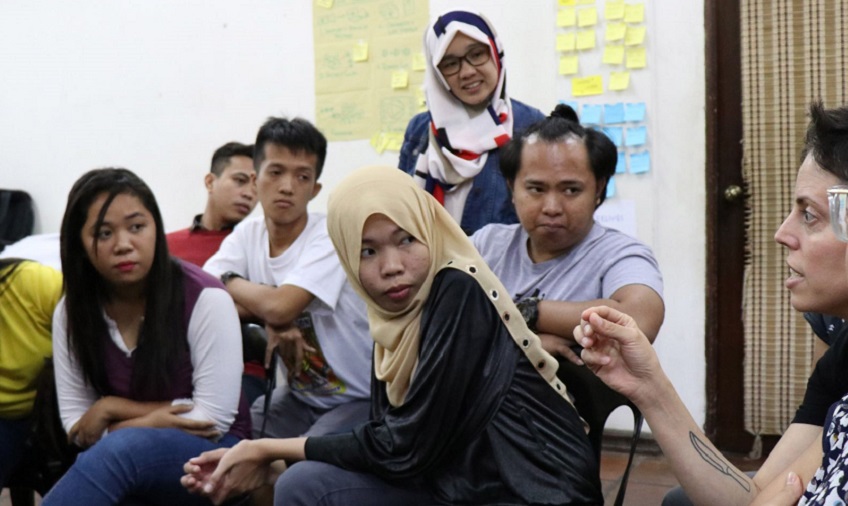 Naila and other PV participants listen intently to the facilitator