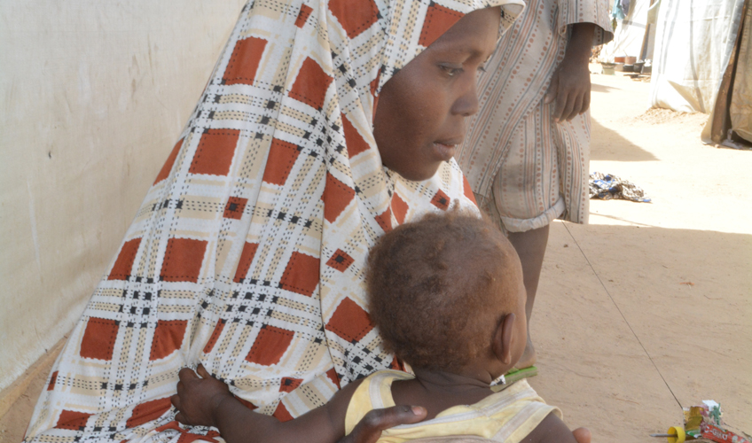A side view of Habiba with her child.