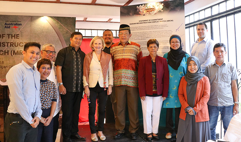 A group of smiling men and women