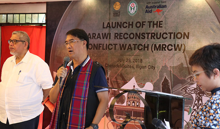 A Filipino man speaks to people using a microphone